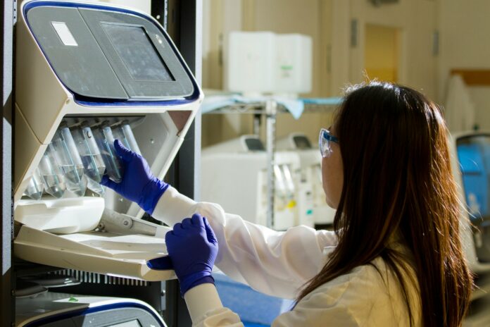 Photo by National Cancer Institute woman holding test tubes