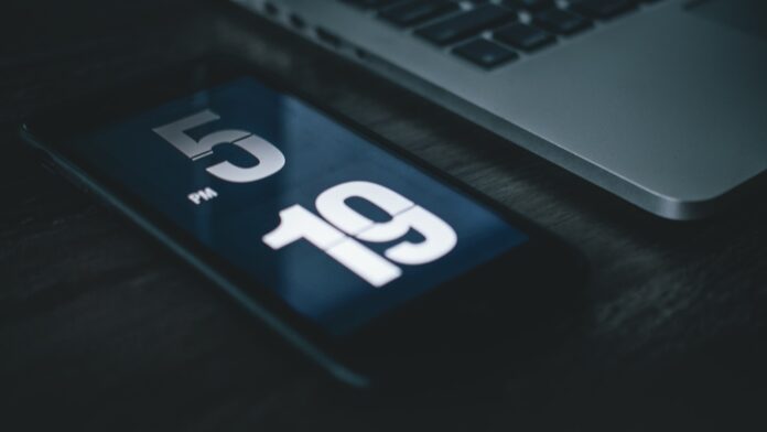 Photo by Luke van Zyl black smartphone beside laptop