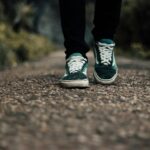 “나를 돌보는 일상이 정신건강을 바꾼다” a person standing on a gravel road with their shoes on