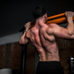 일상 속 ‘근육 키우기’ 열풍…작은 습관이 만드는 건강한 변화 topless man in black shorts holding orange bar